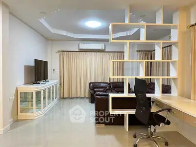 Spacious living room with modern shelving and comfortable seating, perfect for relaxation and entertainment.