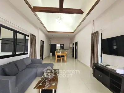 Spacious living room with modern furniture and high ceiling