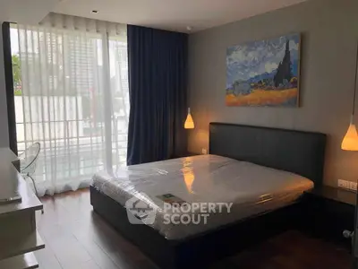 Modern bedroom with large window and stylish decor in urban apartment