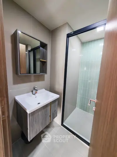 Modern bathroom with sleek vanity and glass shower enclosure