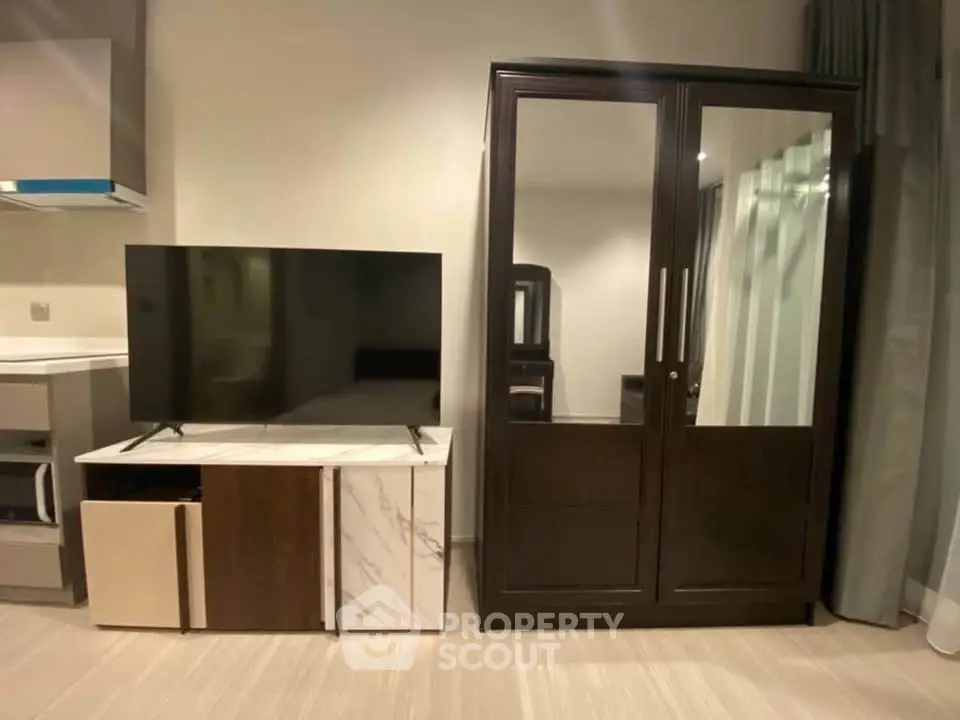 Modern living room with sleek TV stand and elegant wardrobe