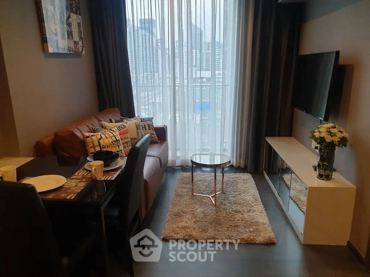 Modern living room with city view, cozy seating, and stylish decor