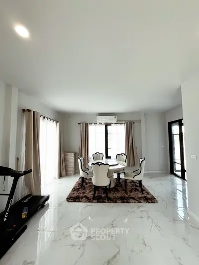 Elegant living room with marble flooring, stylish dining set, and treadmill, perfect for modern living.