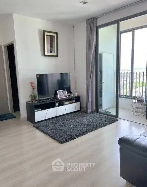 Modern living room with balcony view and sleek entertainment setup