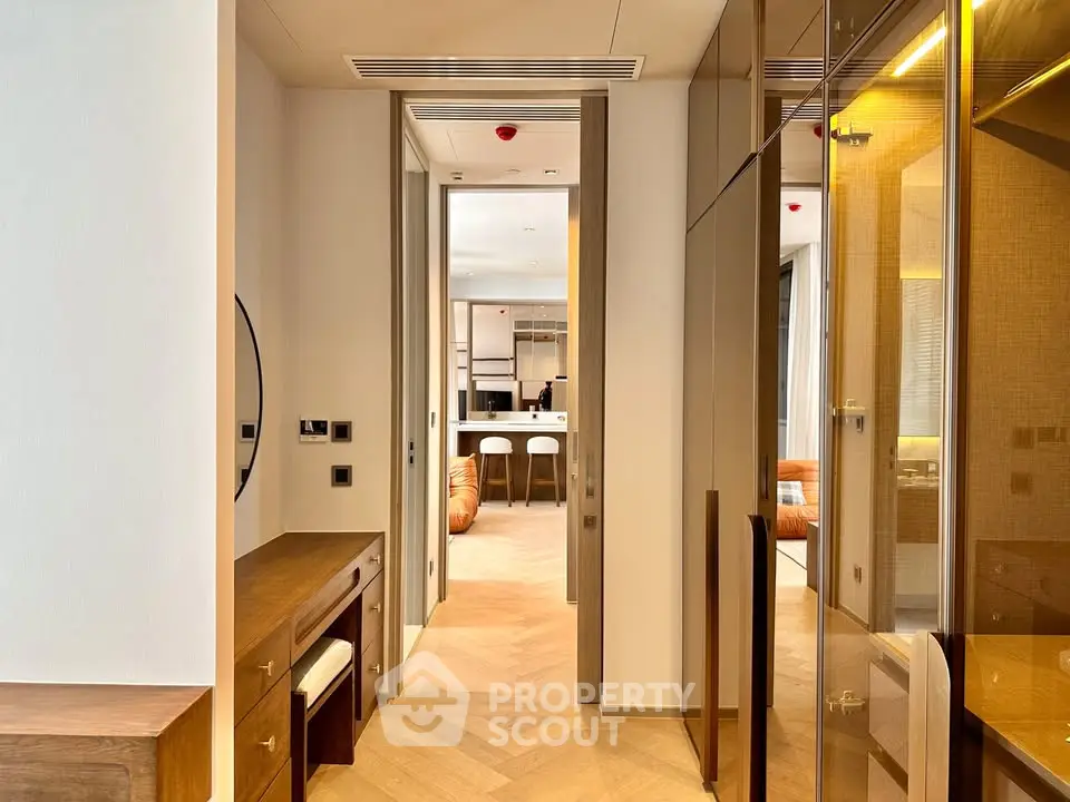 Luxurious hallway leading to a modern open-plan living area with elegant furnishings.
