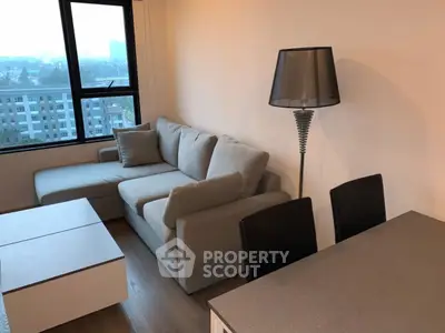 Modern living room with stylish furniture and city view, perfect for urban living.