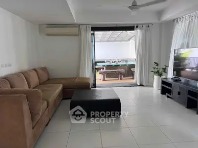 Spacious living room with modern furniture and outdoor dining area view.