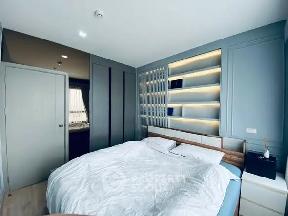 Modern bedroom with stylish built-in shelving and cozy ambiance
