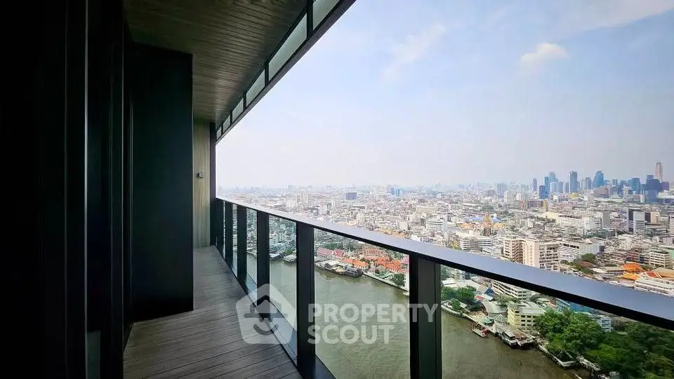 Stunning high-rise balcony with panoramic city and river views, perfect for urban living.