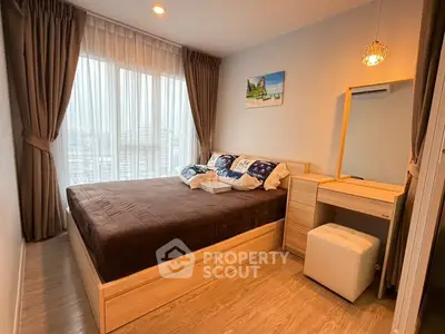 Cozy bedroom with large window and modern decor in a stylish apartment.
