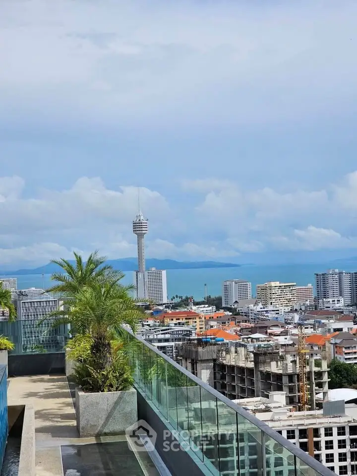 Stunning rooftop view of city skyline and ocean, perfect for urban living.