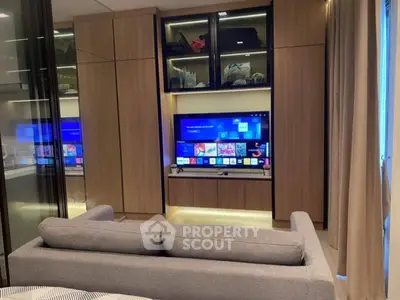 Modern living room with sleek entertainment center and cozy gray sofa