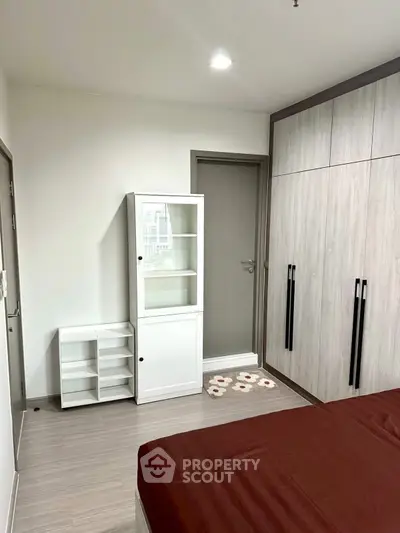 Modern bedroom with sleek wardrobe and minimalist decor