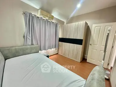 Cozy bedroom with modern furniture and soft lighting, featuring a comfortable bed and spacious wardrobe.