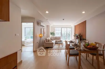 Spacious open-plan living and dining area with modern decor and natural light.