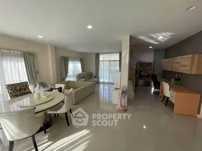 Spacious open-plan living and dining area with modern furnishings and ample natural light.