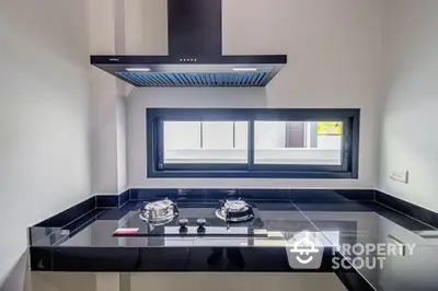 Modern kitchen with sleek black countertops and gas stove