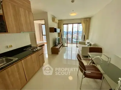 Modern open-plan living room with kitchen and city view balcony