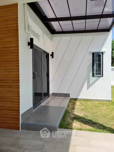 Modern exterior with sleek sliding doors and wooden paneling