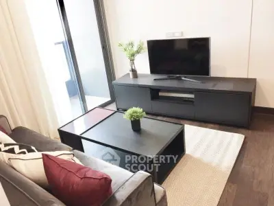 Modern living room with sleek furniture and balcony access