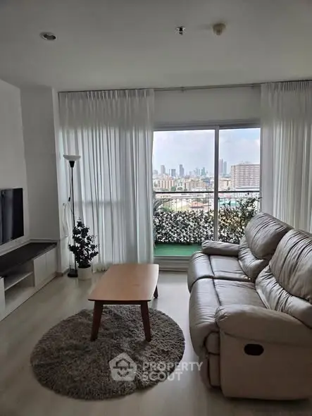 Modern living room with cozy sofa and city view balcony, perfect for relaxation and urban living.