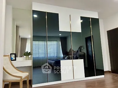 Modern bedroom with mirrored wardrobe and elegant decor