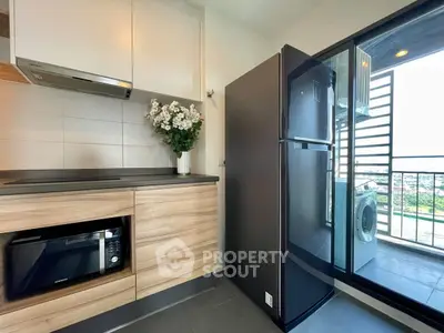 Modern kitchen with sleek appliances and balcony view