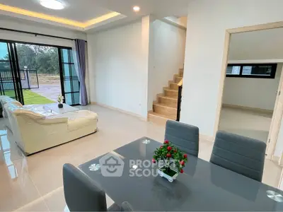 Modern open-plan living and dining area with stylish furniture and natural light.