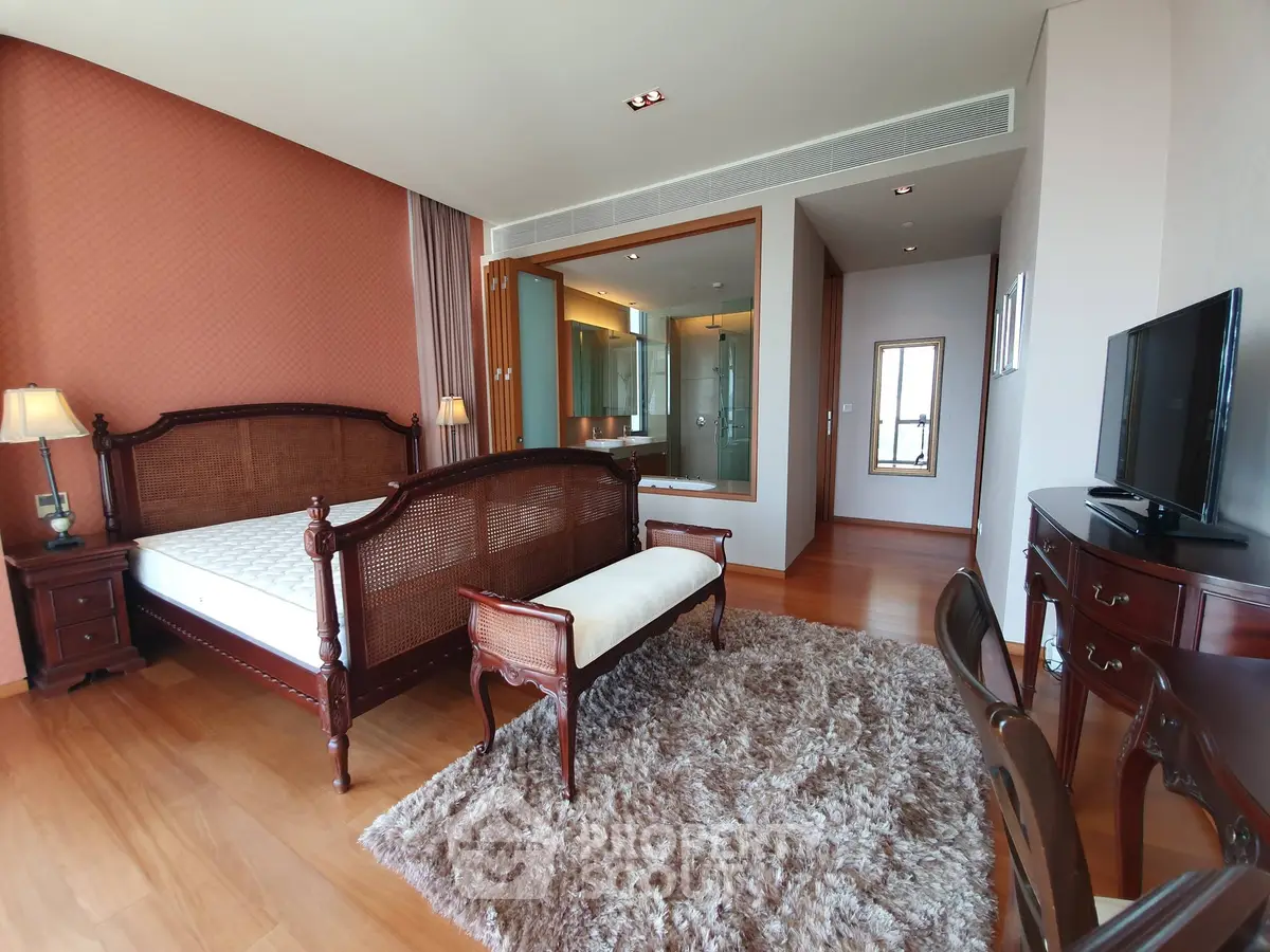 Luxurious bedroom with elegant wooden furniture and ensuite bathroom in modern apartment