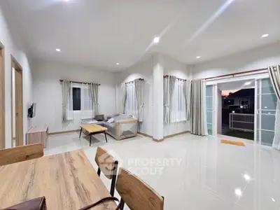 Spacious modern living room with open layout and large windows
