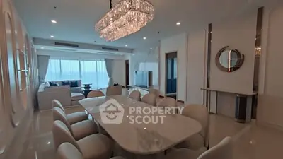 Luxurious living room with elegant chandelier and spacious dining area.