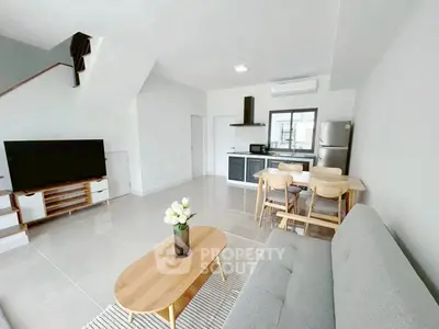 Spacious modern living room with open kitchen and stylish furniture