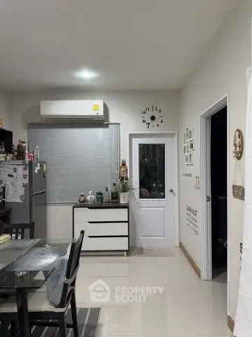 Modern kitchen with sleek dining area and air conditioning unit