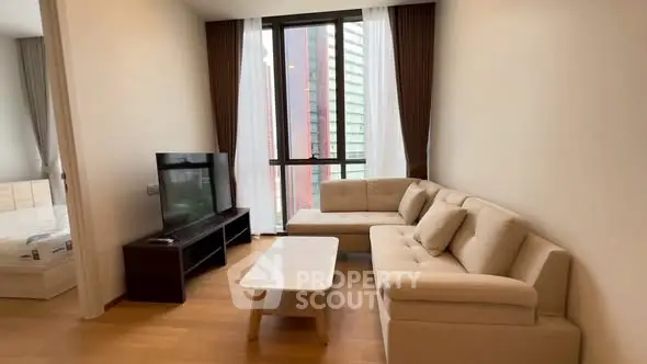 Modern living room with beige sofa and large window view