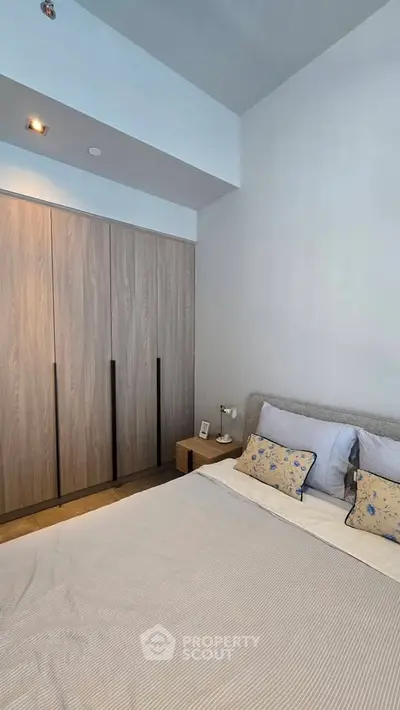Modern bedroom with stylish wardrobe and cozy bed setup