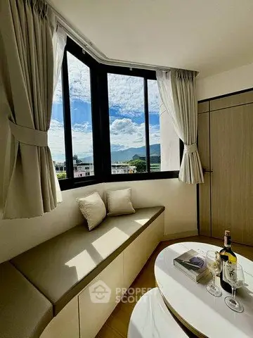 Bright corner unit with stunning view, featuring cozy seating and elegant decor, perfect for relaxation.