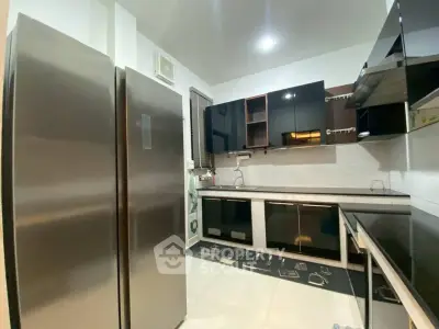 Modern kitchen with sleek appliances and ample storage space