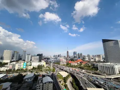 Stunning cityscape view showcasing modern skyline and bustling highways under a clear blue sky.