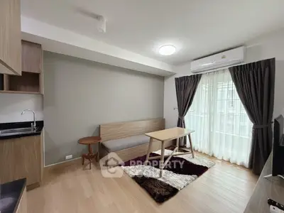 Modern living room with sleek design, featuring a cozy sofa, stylish table, and natural light from large windows.