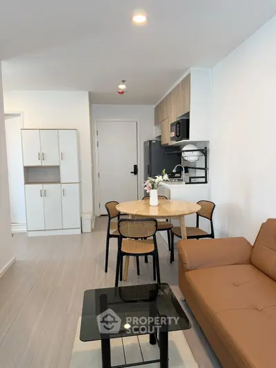 Modern living room with stylish furniture and open kitchen layout