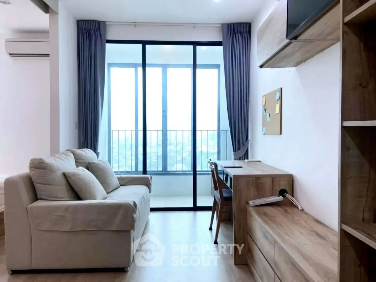 Modern living room with balcony view, cozy sofa, and stylish wooden furniture.