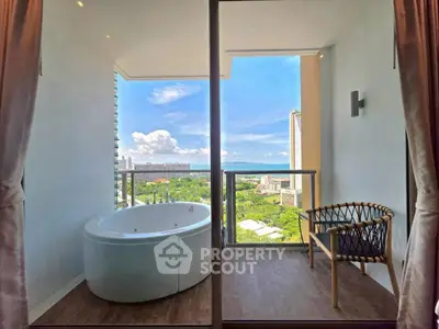 Luxurious balcony with stunning view and private bathtub in modern high-rise apartment.