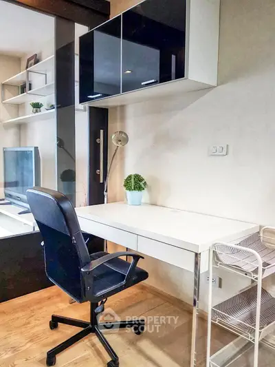 Modern study room with sleek desk, ergonomic chair, and stylish shelving in a contemporary apartment.