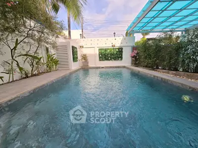 Luxurious private pool with modern design and lush greenery, perfect for relaxation and entertainment.