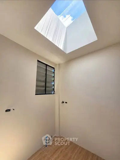 Minimalist bathroom with skylight and modern design