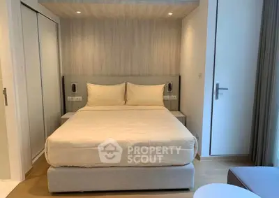 Modern bedroom with cozy bed and elegant decor in a stylish apartment.