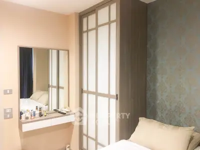 Cozy bedroom with elegant wallpaper and sliding wardrobe doors