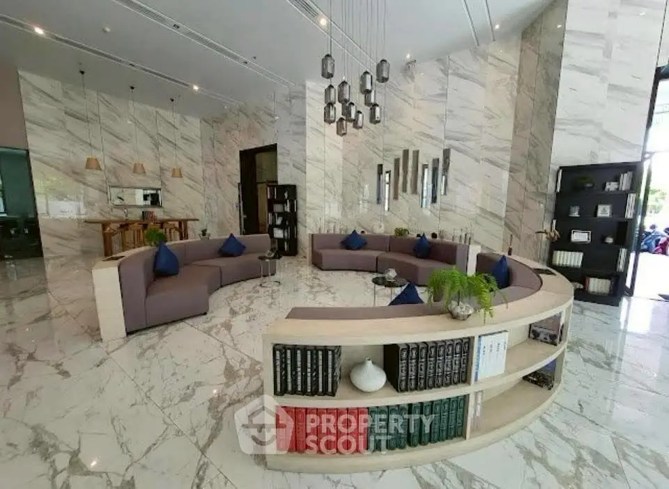 Luxurious modern living room with marble floors and elegant circular seating area.