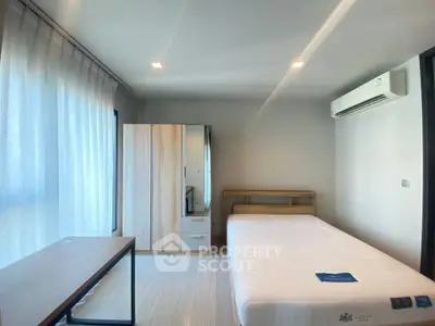 Spacious bedroom with modern furnishings and natural light