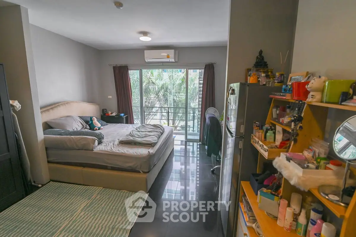 Cozy bedroom with balcony view in modern apartment